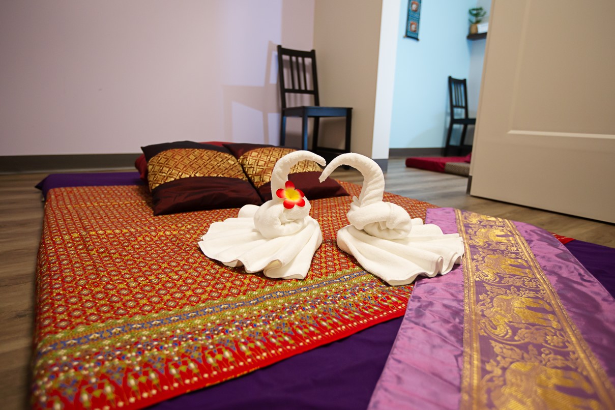 thai massage mat with decorative towels and sheets